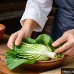 김치 담그는 방법 - A vibrant close-up image of fresh napa cabbage leaves being hand-rubbed with coarse salt in a tradit...