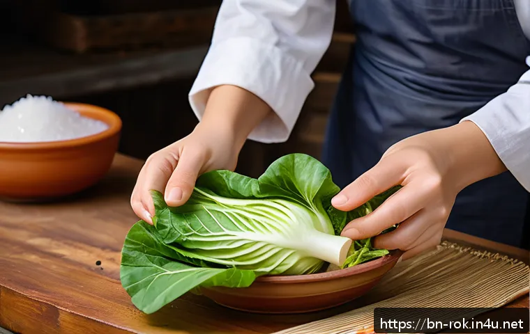 김치 담그는 방법 - A vibrant close-up image of fresh napa cabbage leaves being hand-rubbed with coarse salt in a tradit...